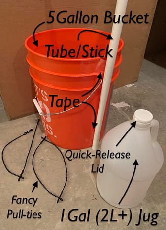 orange five gallon bucket with white tube taped to the side in front of a cardboard box